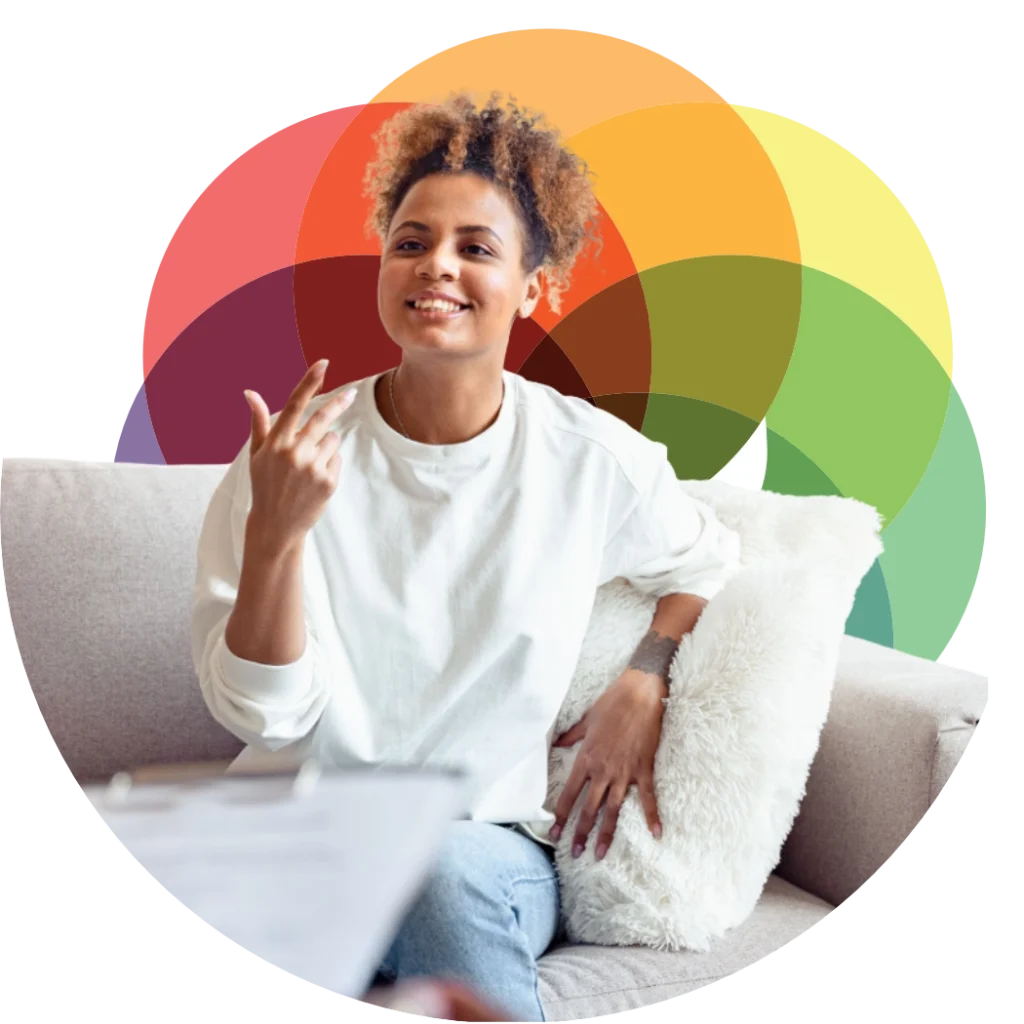 Woman smiling talking to a therapist with Mind Right logo backdrop